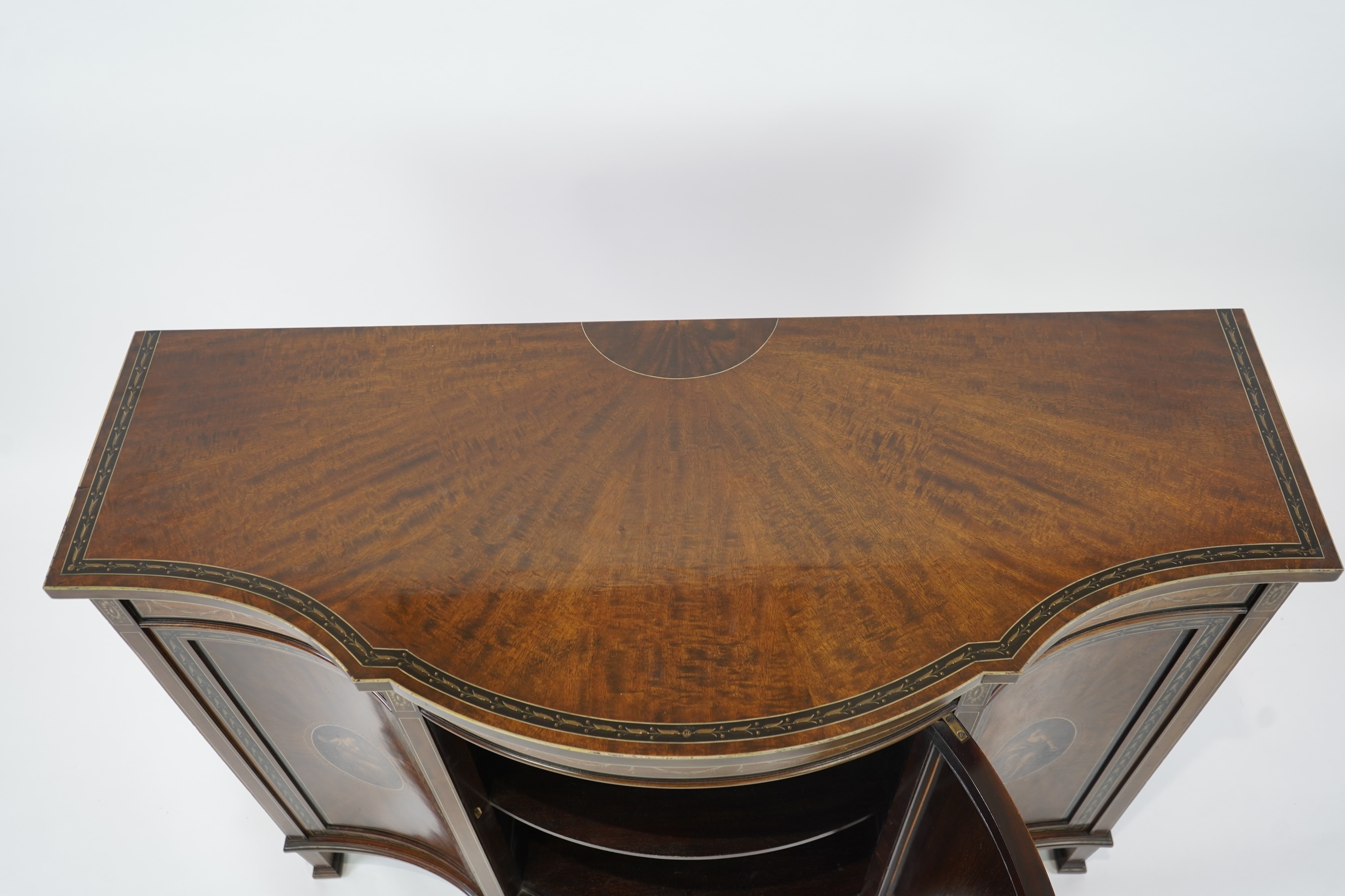 An Edwardian Sheraton Revival painted mahogany bowfront side cabinet